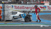 a race car is on a track with a totalenergie sign in the background