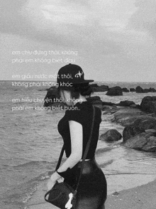 a black and white photo of a woman on a beach