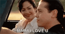 a man and a woman are sitting in a car and the man is telling the woman he loves her .