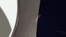 a close up of an airplane window with a light coming through