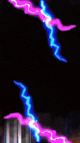 a purple and blue lightning bolt is coming from a dark background