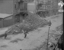 a black and white photo of a city street with the pathe logo on the bottom