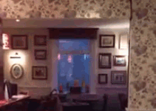 a room with a lot of pictures on the wall and a window