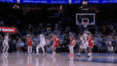 a basketball game is being played in front of a banner for state farm
