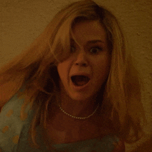 a woman with a pearl necklace has her mouth wide open