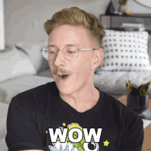 a man wearing glasses and a black shirt that says wow
