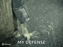 a drainpipe is pouring water into a body of water with the words `` my defense '' written on it .