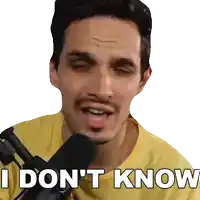 a man in a yellow shirt is holding a microphone and saying i don 't know