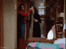 a man in a superhero costume is standing next to two other men in a living room