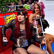 a woman with crutches sits next to a woman with a ring belt .