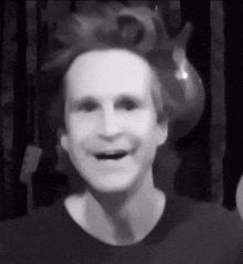a black and white photo of a man 's face with his mouth open