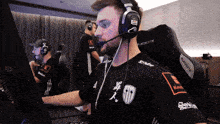 a man wearing headphones and a shirt that says staff