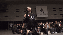 a woman is standing in a wrestling ring with a sign behind her that says ' star ' on it