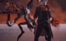 a man in a cowboy hat stands next to a monster
