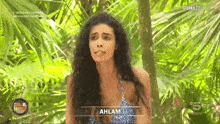 a woman in a bikini is on a television show called isola dei famosi