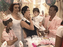 a woman blowing out a candle on a birthday cake