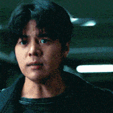 a close up of a young man 's face with a serious look on his face