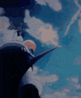 a person is flying through the air with a sword in their hand .