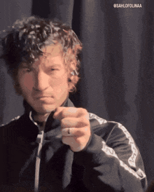 a man in a black jacket is pointing at the camera with the hashtag @sahlofolinaa above him