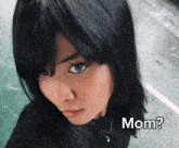 a close up of a woman 's face with the words mom written below her