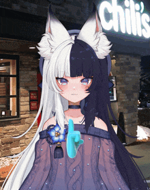 a girl with half black and half white hair stands in front of a chili 's sign