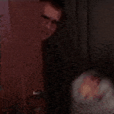 a man is standing in front of a door with a ghost wrapped in plastic .