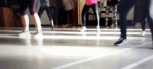 a group of people are dancing in a room with a sign that says ' exit ' on it