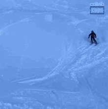 a person on skis is doing a trick with a collab clips logo behind them