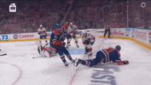 a hockey game is being played in front of a castrol ad
