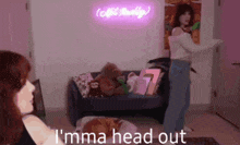 a woman is dancing in front of a neon sign that says i 'mma head out .