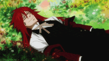 a man with red hair is laying down in a field