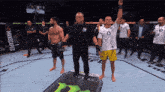 a referee stands in front of a monster energy sign