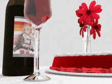 a bottle of wine and a glass of wine next to a cake