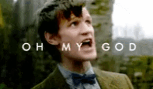a man in a suit and bow tie is screaming with the words oh my god written above him .