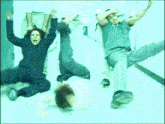 a group of people are dancing in a hallway with their arms in the air