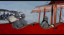 a group of soldiers are sitting in a red airplane