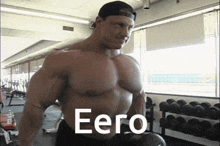 a muscular man in a gym with the word eero written on his chest