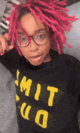 a girl with pink hair and glasses is wearing a shirt that says mit