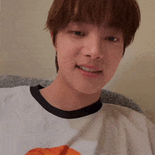 a close up of a person wearing a white shirt