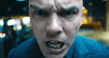 a close up of a man 's face with a very angry look on his face