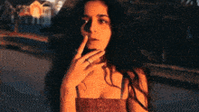 a woman with long hair is smoking a cigarette