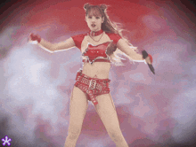 a woman in a red outfit is holding a microphone in her hand