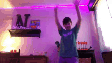 a boy is dancing in front of a shelf with a superman poster on it