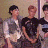 a group of people standing next to each other in a room .