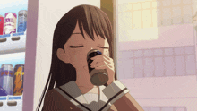 a girl drinking from a can that says ' red bull ' on it