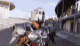 a man in armor is walking down a street .
