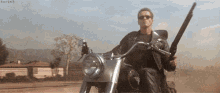 a man is riding a motorcycle while holding a gun