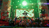 a group of people are dancing in front of a wall that has graffiti on it that says bumps