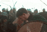 a man holding a shield in front of a crowd with the words lord-aldhelm gifs on the bottom