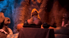 a group of stuffed animals are sitting around a table eating fruit